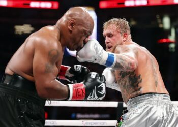 Jake Paul lands a punch on Mike Tyson during their fight at AT&T Stadium in Arlington, Texas.