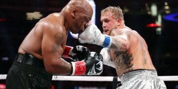 Jake Paul lands a punch on Mike Tyson during their fight at AT&T Stadium in Arlington, Texas.