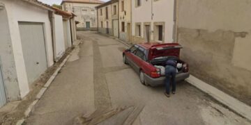 A Google Maps image showing a man leaning over the trunk of a car in Tajueco, Spain.