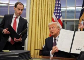 U.S. President Donald Trump signs pardons for January 6 defendants in the Oval Office at the White House on Inauguration Day in Washington, U.S.