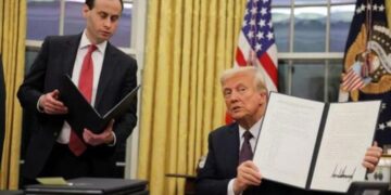 U.S. President Donald Trump signs pardons for January 6 defendants in the Oval Office at the White House on Inauguration Day in Washington, U.S.