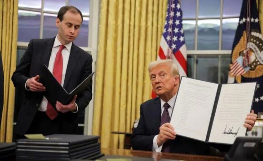 U.S. President Donald Trump signs pardons for January 6 defendants in the Oval Office at the White House on Inauguration Day in Washington, U.S.