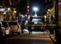 Police officers stand at the scene where a truck drove into a large crowd on Bourbon Street in the French Quarter .